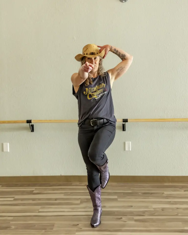HealthSPORT instructor in a cowboy hat and boots posing in a studio